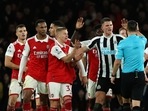 Referee Andy Madley discusses with players during the English Premier League soccer match between Arsenal and Newcastle United at Emirates stadium in London, Tuesday, Jan. 3, 2023. (AP Photo/Ian Walton)