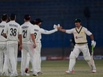 Pakistan's Naseem Shah (R) shakes hands with New Zealand's players at the end of the second cricket Test match between Pakistan and New Zealand at the National Stadium in Karachi on January 6, 2023. 