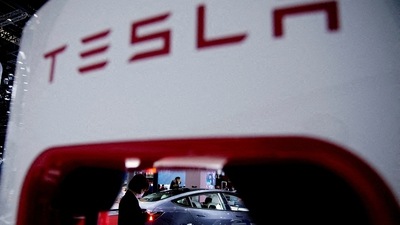 Tesla Price Cut In China: A Tesla electric vehicle is seen through a charging point. (Reuters)