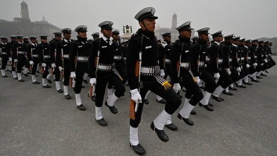 An Indian Navy contingent is seen rehearsing for the Republic Day parade on Kartavya Path on a foggy morning, on January 6. Delhi recorded a cold wave for a second day on the trot on Friday, with the minimum temperature at Ayanagar in southwest Delhi plunging to a numbing 1.8 degrees Celsius, PTI reported.(Raj K Raj / HT Photo)