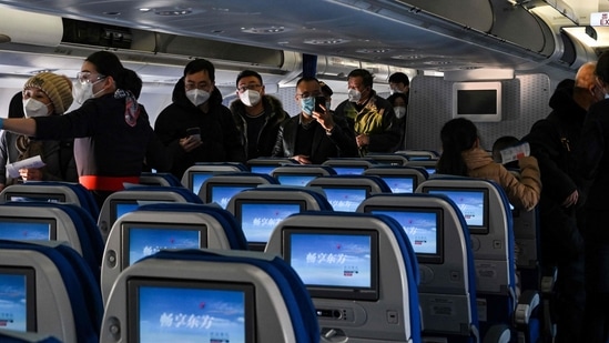 People board a domestic flight at Harbin Taiping International Airport in Harbin, in China's northeastern Heilongjiang province. (AFP)