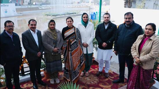 Chandigarh mayor Sarbjit Kaur (in white jacket) with other civic body officials after dedicating under a pond revived under the ‘Amrit Sarovar’ mission at Khuda Ali Sher on Saturday. (HT Photo)
