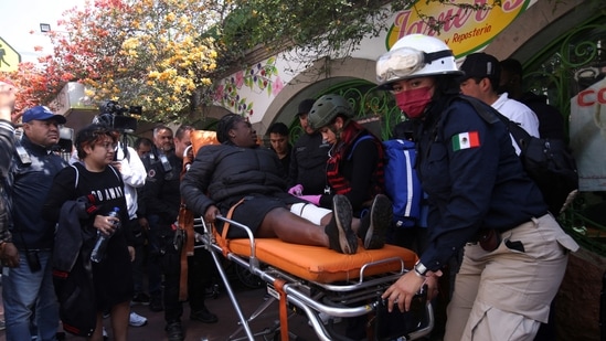 Paramedics assist a woman after two subway trains collide head-on at a subway station, in Mexico City.(REUTERS)