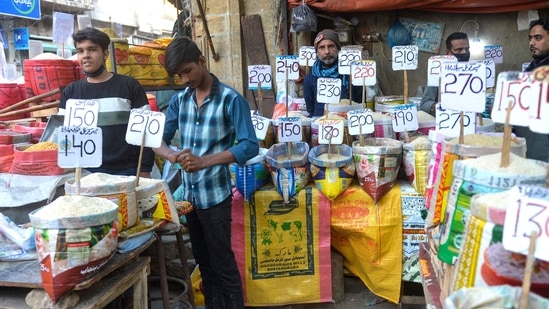 Pakistan Inflation: Shopkeepers fix the price tags of rice at a market in Karachi.(AFP)