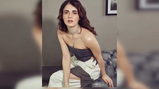 For her latest photoshoot, Radhika Madan wore a grey tie-up bandeau top which she paired with cut-out cargo pants. (Instagram/@radhikamadan)