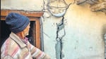 A man shows cracks in his house at Joshimath. (PTI) A man shows cracks in his house at Joshimath. (PTI)