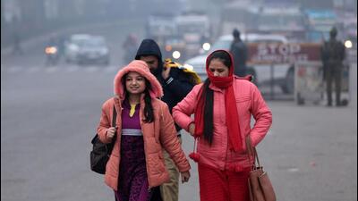 People clad in woollens in Jammu on Sunday. (PTI) People clad in woollens in Jammu on Sunday. (PTI)