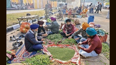 Protesters readying vegetables for meals at the YPS Chowk on the Chandigarh-Mohali border on Sunday. They have refused to leave until the CM and governor agree to meet them. (Keshav Singh/HT)