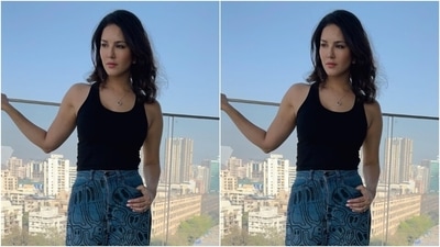 Sunny posed in her balcony in a black tank top, tucked inside a blue pair of jeans featuring quirky patterns in shades of black, and wide legs. (Instagram/@sunnyleone) Sunny posed in her balcony in a black tank top, tucked inside a blue pair of jeans featuring quirky patterns in shades of black, and wide legs. (Instagram/@sunnyleone)