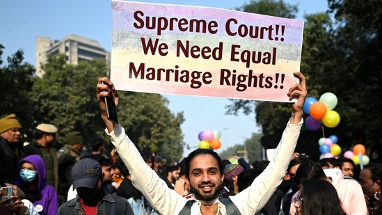 A Pride walk participant holding a placard demanding equal marriage rights for the community. (AFP)