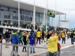 Supporters of Brazilian former President Jair Bolsonaro invade Planalto Presidential Palace in Brasilia.(AFP)