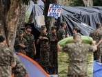 Soldiers clear out an encampment set up by supporters of former Brazilian President Jair Bolsonaro outside army headquarters, where a sign reads in Spanish Soldiers clear out an encampment set up by supporters of former Brazilian President Jair Bolsonaro outside army headquarters, where a sign reads in Spanish