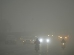 Vehicles ply on a road during a foggy and cold winter day, in Gurugram,(PTI) Vehicles ply on a road during a foggy and cold winter day, in Gurugram,(PTI)