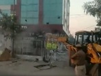 According to the authorities, the building was built illegally and officials reached the site with JCBs to tear it down in the presence of police.(ANI) According to the authorities, the building was built illegally and officials reached the site with JCBs to tear it down in the presence of police.(ANI)