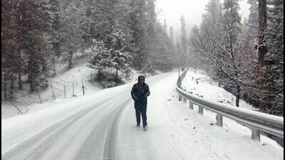 A man walks on a snow-covered Tangmarg- Gulmarg road on Monday. (Mohammad Amin War) A man walks on a snow-covered Tangmarg- Gulmarg road on Monday. (Mohammad Amin War)
