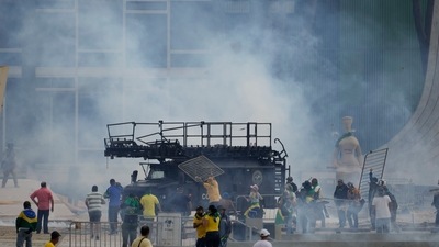 Brazil Government Buildings Raid: Protesters, supporters of Brazil's former President Jair Bolsonaro, attack a police armored vehicle. (AP) Brazil Government Buildings Raid: Protesters, supporters of Brazil's former President Jair Bolsonaro, attack a police armored vehicle. (AP)