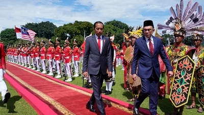 Malaysian Prime Minister Anwar Ibrahim, right, inspects honor guards with Indonesian President Joko Widodo during their meeting. (AP) Malaysian Prime Minister Anwar Ibrahim, right, inspects honor guards with Indonesian President Joko Widodo during their meeting. (AP)