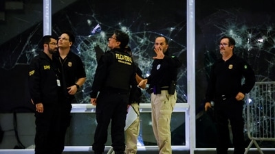 Police inspect damage at the Supreme Court building following protests by supporters of Brazil's former President Jair Bolsonaro against President Luiz Inacio Lula da Silva in Brasilia on Monday. (REUTERS)