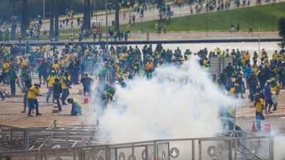 Smoke is pictured as supporters of Brazil's former President Jair Bolsonaro hold a demonstration against President Luiz Inacio Lula da Silva, outside Brazil’s National Congress in Brasilia, Brazil, January 8, 2023. (REUTERS/Adriano Machado)