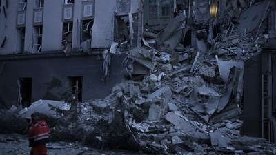 Russia-Ukraine War: An emergency worker walks in front of a damaged hotel following a Russian attack in Kyiv. (AP) Russia-Ukraine War: An emergency worker walks in front of a damaged hotel following a Russian attack in Kyiv. (AP)