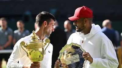 Serbia's Novak Djokovic poses with the trophy after winning the Wimbledon men's singles final alongside runner up Australia's Nick Kyrgios (REUTERS)