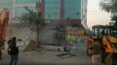 According to the authorities, the building was built illegally and officials reached the site with JCBs to tear it down in the presence of police. (ANI) According to the authorities, the building was built illegally and officials reached the site with JCBs to tear it down in the presence of police. (ANI)