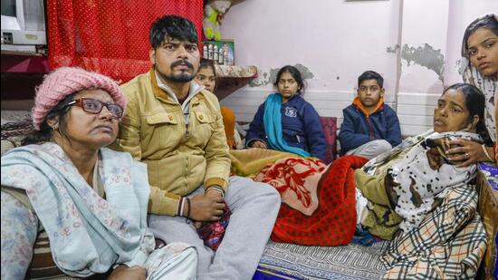 Family members of 20-year-old Anjali Kumari, who was killed after being hit and dragged by a car, at their residence. (PTI)