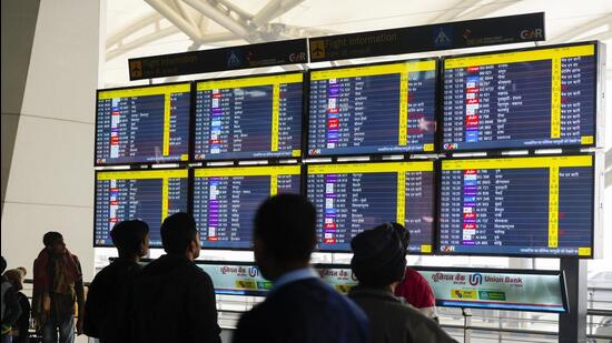 Passengers check arrival and departure time of flights at Indira Gandhi International Airport in New Delhi on Monday morning. (PTI) Passengers check arrival and departure time of flights at Indira Gandhi International Airport in New Delhi on Monday morning. (PTI)