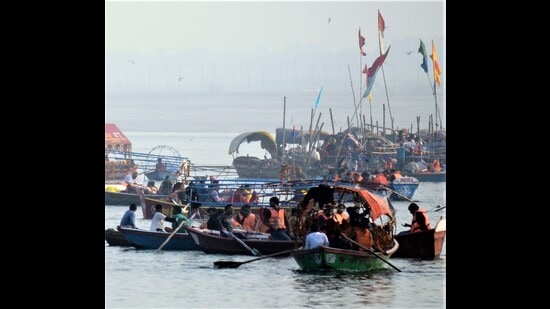 Pilgrims wearing life jackets on a boat at Sangam. (HT photo)