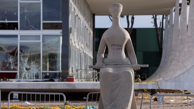 Graffiti scribbled on the ‘Justice’ statue outside the Supreme Federal Court in Brasilia, on January 9. Bolsonaro, 67, took to Twitter Sunday night to condemn the "pillaging" in Brasilia, but rejected Lula's claim he incited the attacks, and defended the right to "peaceful protests." (Amanda Perobelli / Reuters) Graffiti scribbled on the ‘Justice’ statue outside the Supreme Federal Court in Brasilia, on January 9. Bolsonaro, 67, took to Twitter Sunday night to condemn the "pillaging" in Brasilia, but rejected Lula's claim he incited the attacks, and defended the right to "peaceful protests." (Amanda Perobelli / Reuters)