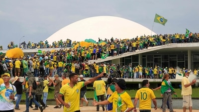 Supporters of former Brazilian President Jair Bolsonaro seen storming the National Congress in Brasilia on January 8. Hundreds of supporters of the far-right ex-president staged a dramatic protest against President Luiz Inacio Lula da Silva's inauguration last week. (Sergio Lima / AFP) Supporters of former Brazilian President Jair Bolsonaro seen storming the National Congress in Brasilia on January 8. Hundreds of supporters of the far-right ex-president staged a dramatic protest against President Luiz Inacio Lula da Silva's inauguration last week. (Sergio Lima / AFP)