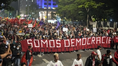 Pro-government demonstrators seen marching with a banner that reads in Portuguese "We are Democracy" in Sao Paulo, on January 9. As the nation continued to come to grips with the stunning violence, hundreds gathered to defend Brazilian democracy and demand punishment for the people who stormed the halls of power a day earlier. (Andre Penner / AFP) Pro-government demonstrators seen marching with a banner that reads in Portuguese "We are Democracy" in Sao Paulo, on January 9. As the nation continued to come to grips with the stunning violence, hundreds gathered to defend Brazilian democracy and demand punishment for the people who stormed the halls of power a day earlier. (Andre Penner / AFP)