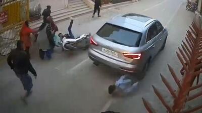 A video grab shows the car driver speeding in order to escape the mob and running over the guard in the process. The guard is undergoing treatment at a private hospital. A video grab shows the car driver speeding in order to escape the mob and running over the guard in the process. The guard is undergoing treatment at a private hospital.