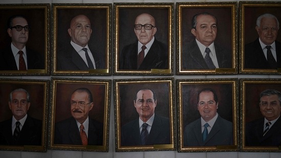 Vandalized paintings of Brazilian senator Renan Calheiros (centre, bottom) and ex-President Jose Sarney (bottom, second left) are seen amid paintings of other political figures, at Planalto Palace in Brasilia on January 9, Brazilian security forces locked down the area around Congress, the presidential palace and the Supreme Court after the incident triggered an international outcry. (Carl De Souza / AFP)
