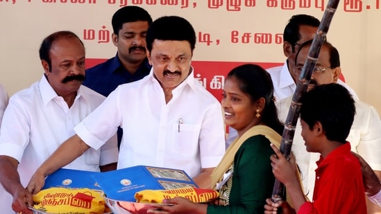 Tami Nadu Chief Minister MK Stalin hands over the Pongal gift hamper to a beneficiary during a programme, at Sathya Nagar, in Chennai on Monday. (ANI Photo)