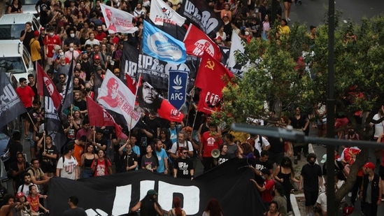 Members of social movements protest in defense of democracy in Porto Alegre, in southern Brazil, on January 9, 2023, a day after supporters of Brazil's far-right ex-president Jair Bolsonaro invaded the Congress, presidential palace, and Supreme Court in Brasilia.(AFP)