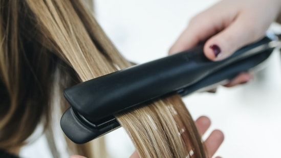 Heat-damaged hair can be caused by using styling tools such as hair dryers, straighteners, and curling irons, as well as chemical treatments like coloring and bleaching(Pexels)