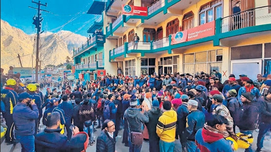 Local residents protest the demolitions near an affected hotel in Joshimath on Tuesday. (PTI)