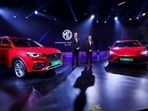 President and Managing Director of MG Motor India Private Limited Rajeev Chaba and Chief Commercial Officer MG Motor India Gaurav Gupta pose with MG EHS, Plug-in Hybrid and MG4 pure electric vehicle at the Auto Expo 2023 in Greater Noida on Wednesday. 