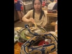 Video shows women dining with 'python,'
