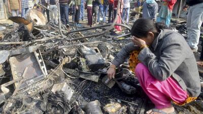 A resident searches for her belongings after the fire was doused in Sector 66, Gurugram on Wednesday. (PTI) A resident searches for her belongings after the fire was doused in Sector 66, Gurugram on Wednesday. (PTI)