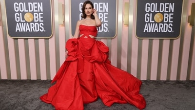 Lily James stuns in a bright red floor-sweeping gown with waist cut-outs and a strapless plunging neckline.&nbsp; (REUTERS)