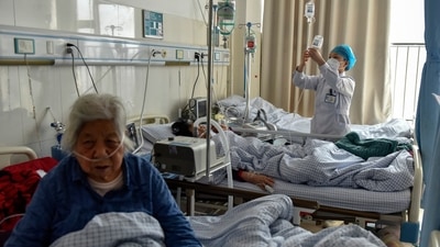 Elderly patients with Covid-19 symptoms receive intravenous drips at the emergency ward of a hospital in Fuyang in central China's Anhui province. (AP/PTI) Elderly patients with Covid-19 symptoms receive intravenous drips at the emergency ward of a hospital in Fuyang in central China's Anhui province. (AP/PTI)
