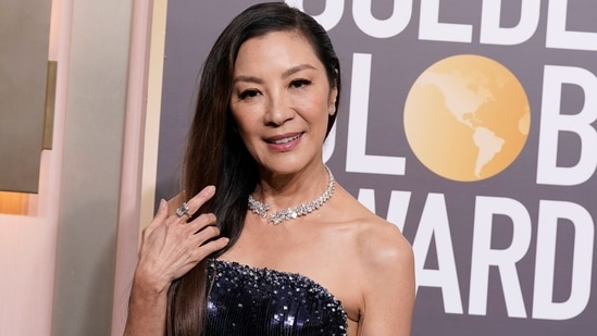 Michelle Yeoh is aging like a fine wine and this image is proof. The actor chose a strapless embellished gown for the 80th Golden Globe Awards styled with a statement diamond necklace, matching ring, ear studs, and open tresses.&nbsp;(Invision)