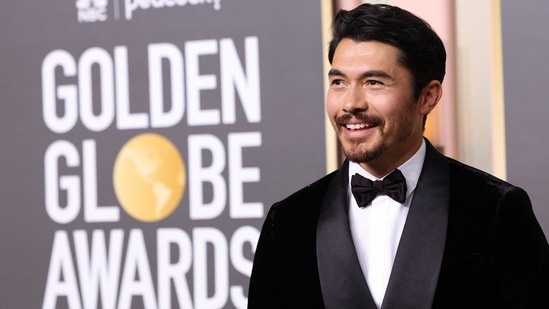 Henry Golding poses for the media at the Golden Globe Awards red carpet.&nbsp;(REUTERS)