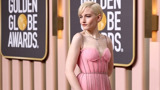Julia Garner looks magical in a baby pink embellished gown featuring a sweetheart neckline, spaghetti straps, and a flowy skirt.&nbsp;(REUTERS)