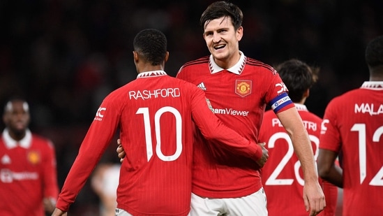 Manchester United's English striker Marcus Rashford celebrates with Manchester United's English defender Harry Maguire after scoring their third goal during the English League Cup quarter final football match between Manchester United and Charlton Athletic, at Old Trafford, in Manchester, north-west England on January 10, 2023. - Man Utd won the game 3-0. (Photo by Oli SCARFF / AFP) / RESTRICTED TO EDITORIAL USE. No use with unauthorized audio, video, data, fixture lists, club/league logos or 'live' services. Online in-match use limited to 120 images. An additional 40 images may be used in extra time. No video emulation. Social media in-match use limited to 120 images. An additional 40 images may be used in extra time. No use in betting publications, games or single club/league/player publications. / (AFP)