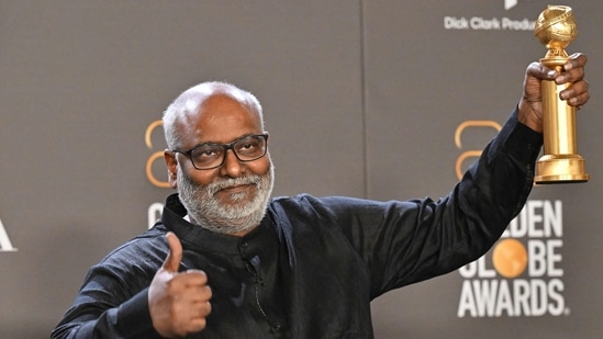 MM Keeravani poses with the trophy for Best Original Song. RRRwon Best Original Song for Naatu Naatu.