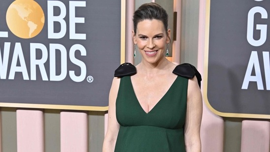 Two-time Oscar winner Hilary Swank, who is pregnant with twins, wowed in a dark green sleeveless Prada gown with pockets and black bows on the shoulders.&nbsp;(AFP)