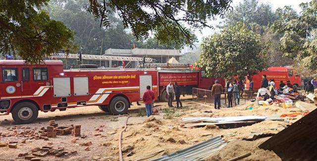 Firefighters douse the blaze on Wednesday. (HT Photo) Firefighters douse the blaze on Wednesday. (HT Photo)